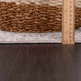 Close-up of the Lugo Luxe Area Rug edge, showing rug thickness with a ruler and a basket detail. Fold