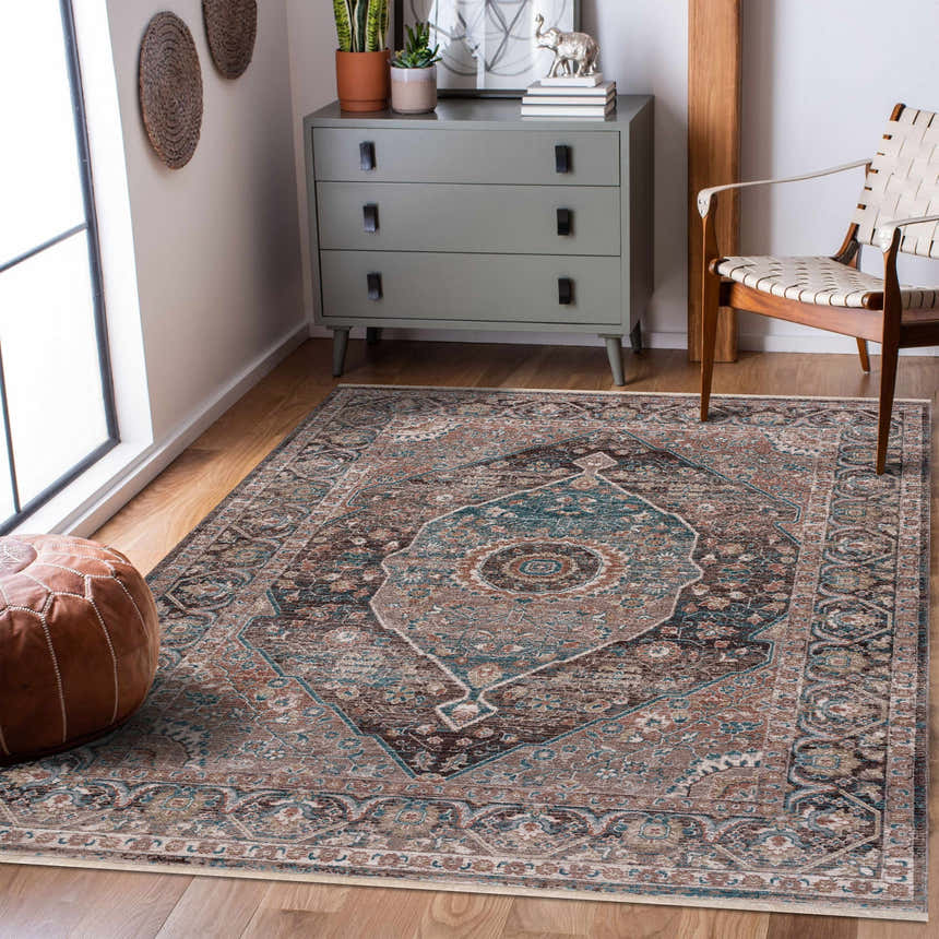 Living room scene with a Baychester Brown Area Rug, gray dresser, woven chair, and brown leather pouf. Roomscene-Rectangle