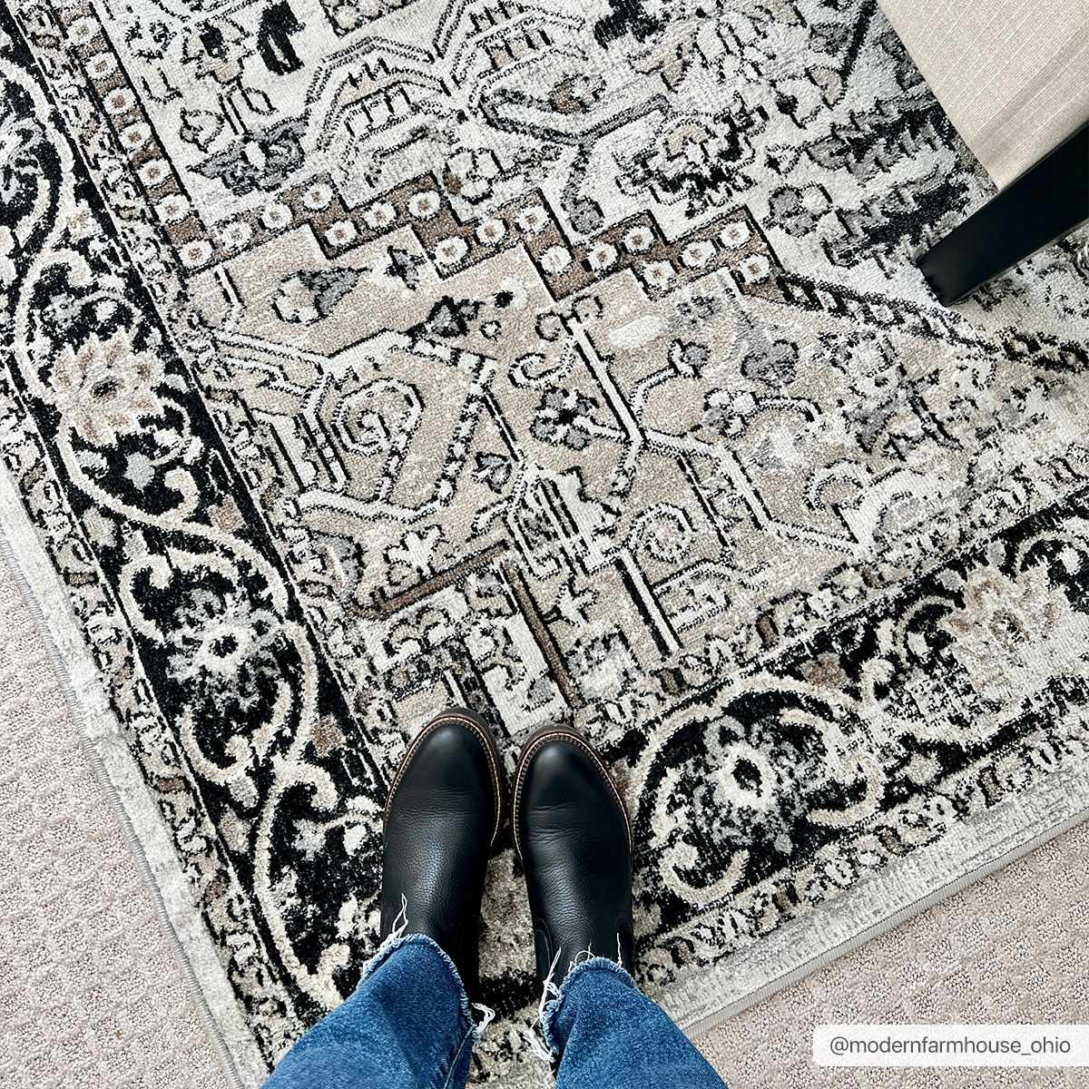 Close-up of the Cabacungan Washable Area Rug. Features a vintage, black, gray, and beige bohemian pattern. Roomscene-Rectangle