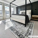 Bedroom scene with black canopy bed and the black and gray vintage Cabacungan Washable Area Rug. Roomscene-Rectangle