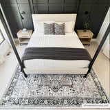Bedroom scene with a black and gray Cabacungan Washable Area Rug under a four-poster bed. Modern farmhouse style. Roomscene-Rectangle