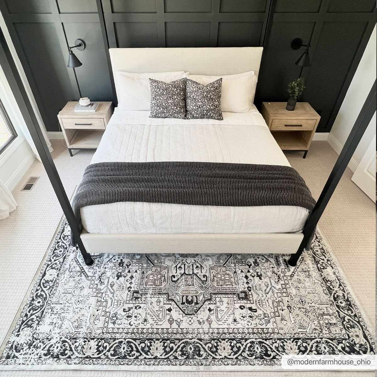 Bedroom scene with a black and gray Cabacungan Washable Area Rug under a four-poster bed. Modern farmhouse style. Roomscene-Rectangle