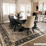 Dining room with a dark wood table on a Cabacungan Washable Area Rug in black, gray, and beige. Farmhouse style. Roomscene-Rectangle
