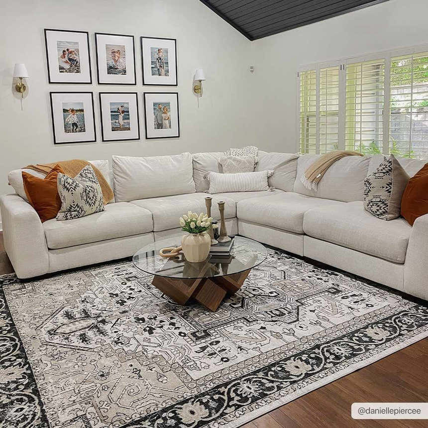 Living room with a neutral sectional sofa and the black and beige Cabacungan Washable Area Rug. Roomscene-Rectangle