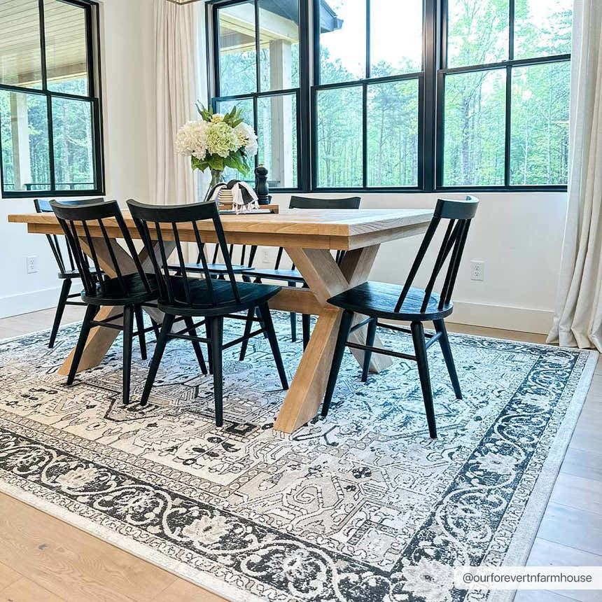 Dining room with wood table, black chairs, and Cabacungan Washable Area Rug in black, gray, and beige. Roomscene-Rectangle