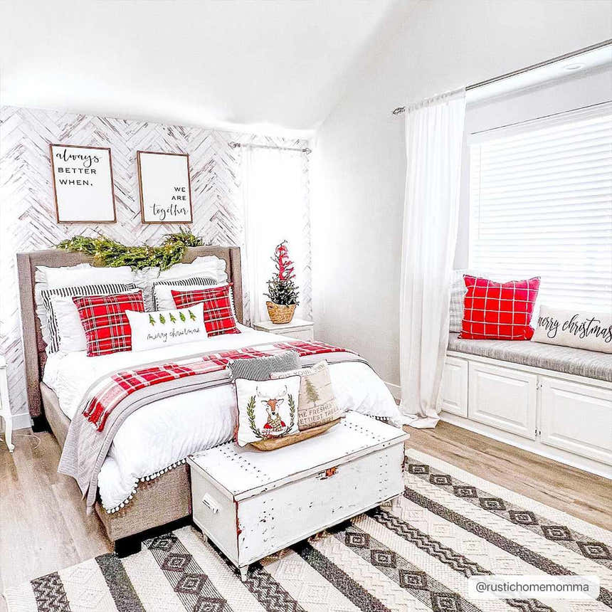 Christmas bedroom scene with a Whittington Black&White Wool Rug, bed, white chest, and red plaid accents. Roomscene-Rectangle