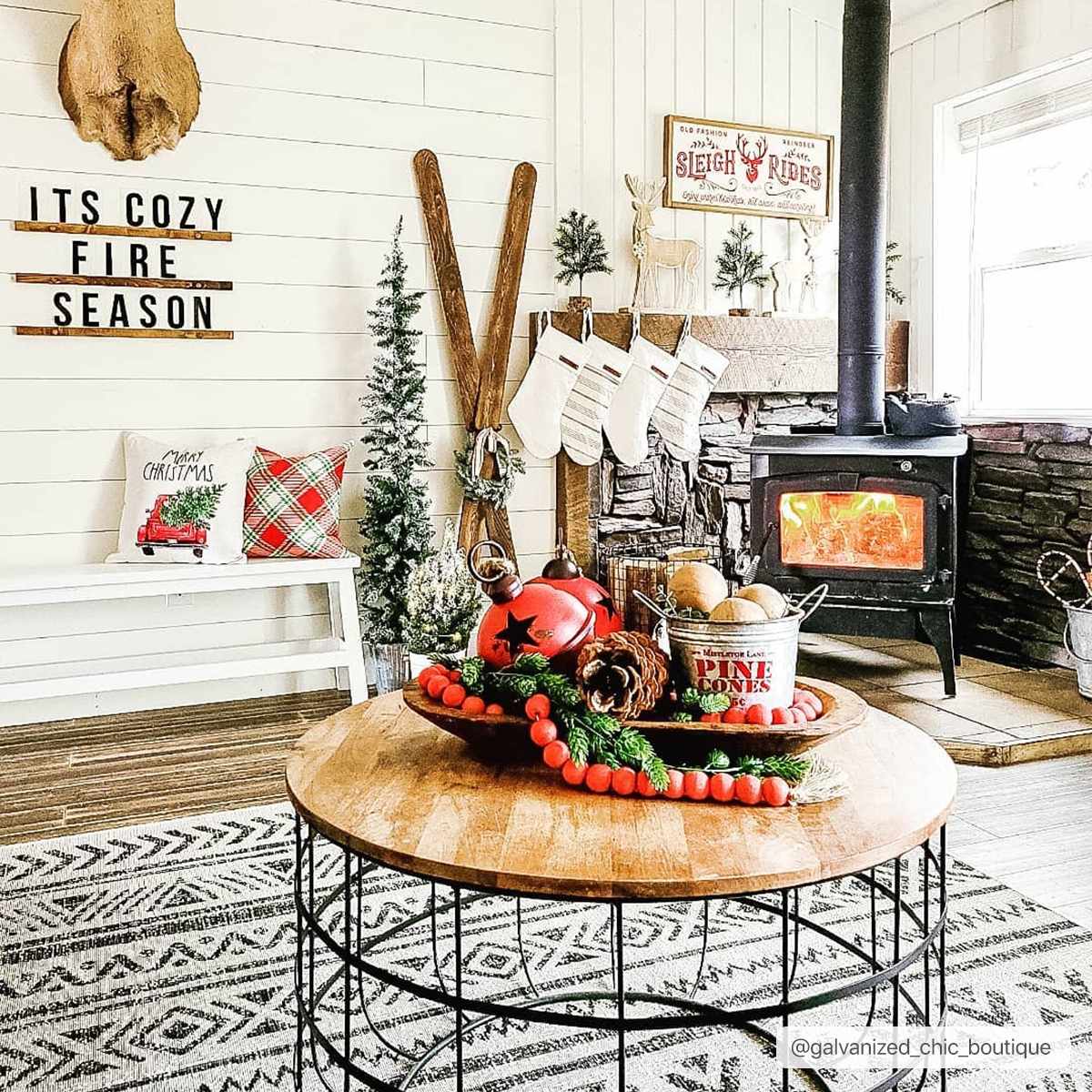Cozy Christmas living room with a black and white Catrine Indoor & Outdoor Rug, wood stove, and holiday decor. Roomscene-Rectangle