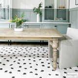 Dining room with light wood table and Chaia Dotted Black & White Plush Rug, creating a modern, cozy feel. Roomscene-Rectangle