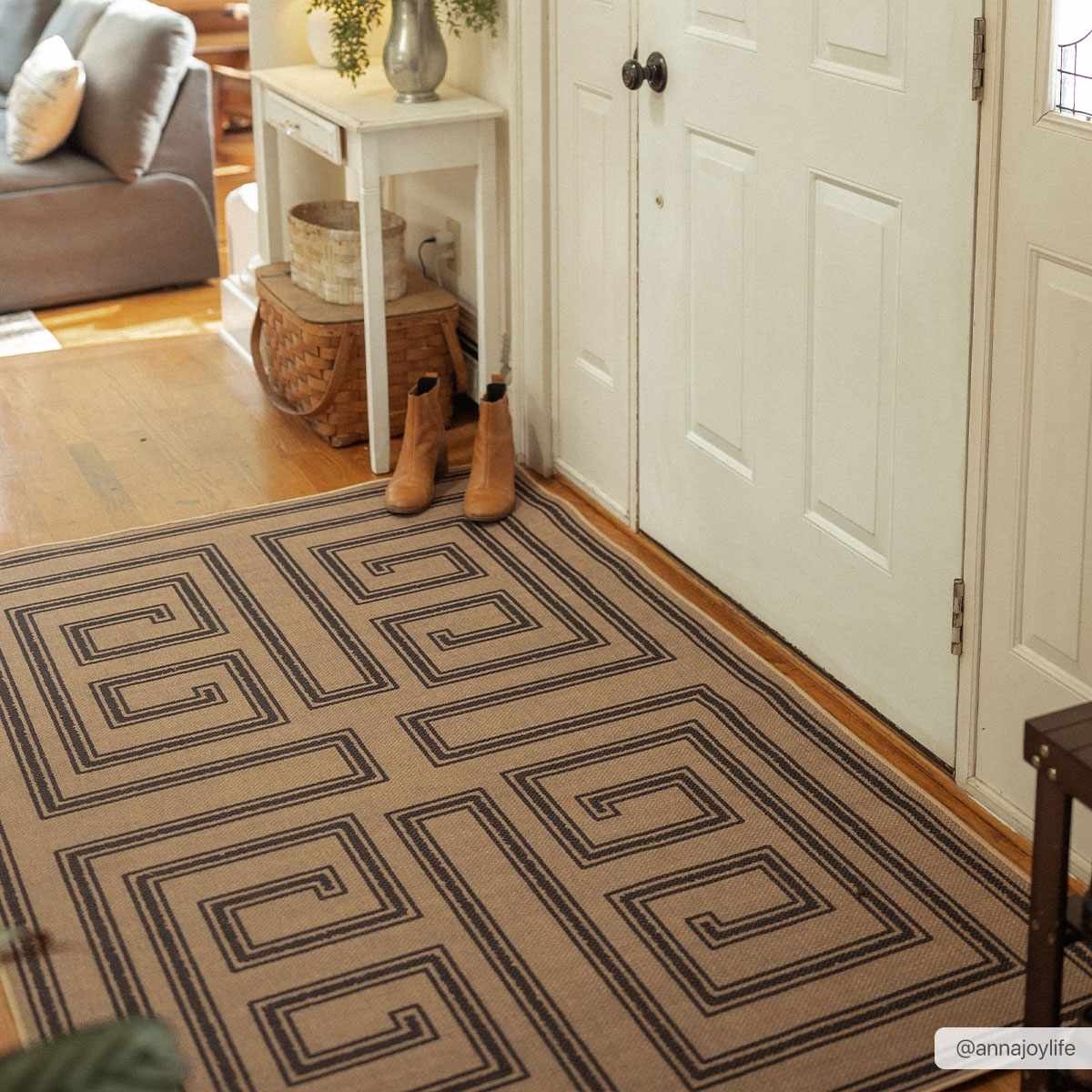 Entryway with Coty Washable Jutely Rug in natural jute and charcoal. Farmhouse style with tan boots and white door. Roomscene-Rectangle