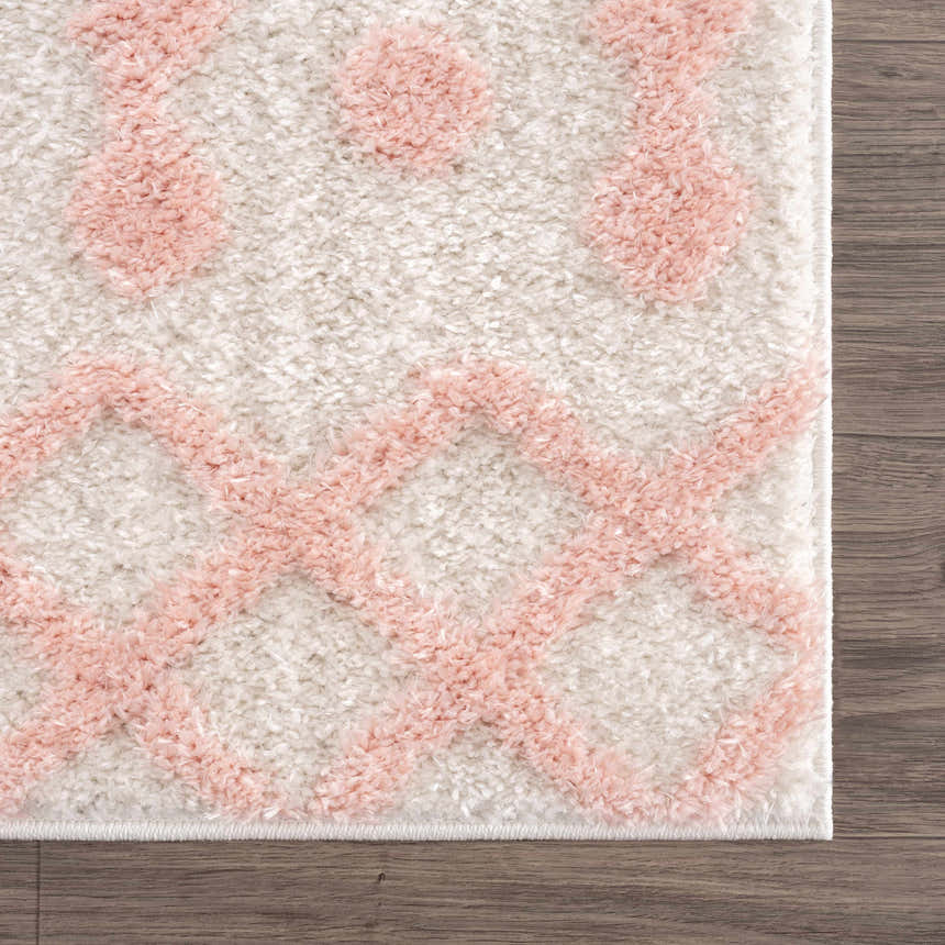 Close-up of the Darva Pink Plush Area Carpet showing the shag texture and geometric pink and white pattern. Swatch
