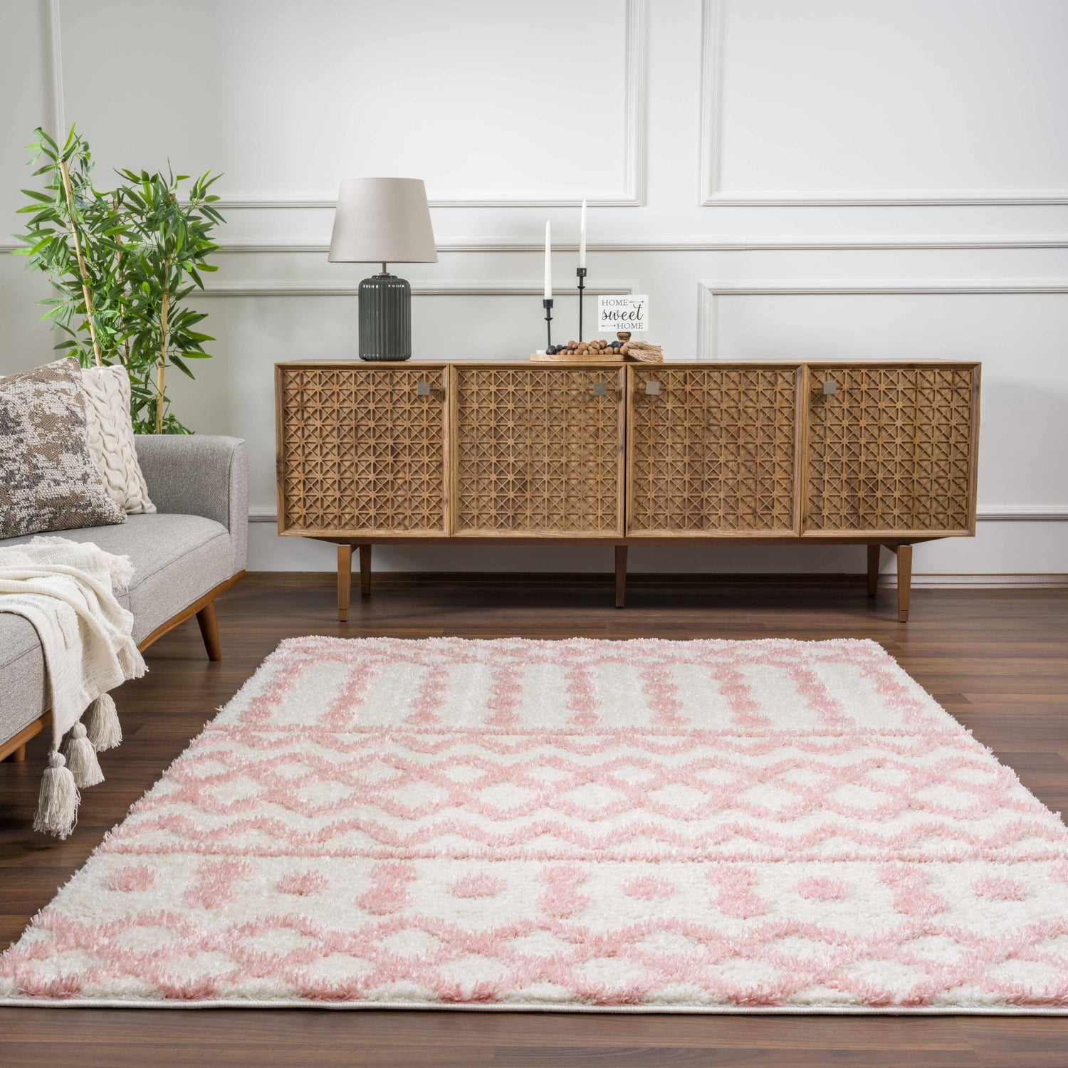 Living room scene with a pink and white geometric patterned Darva Pink Plush Area Carpet. Roomscene-Rectangle