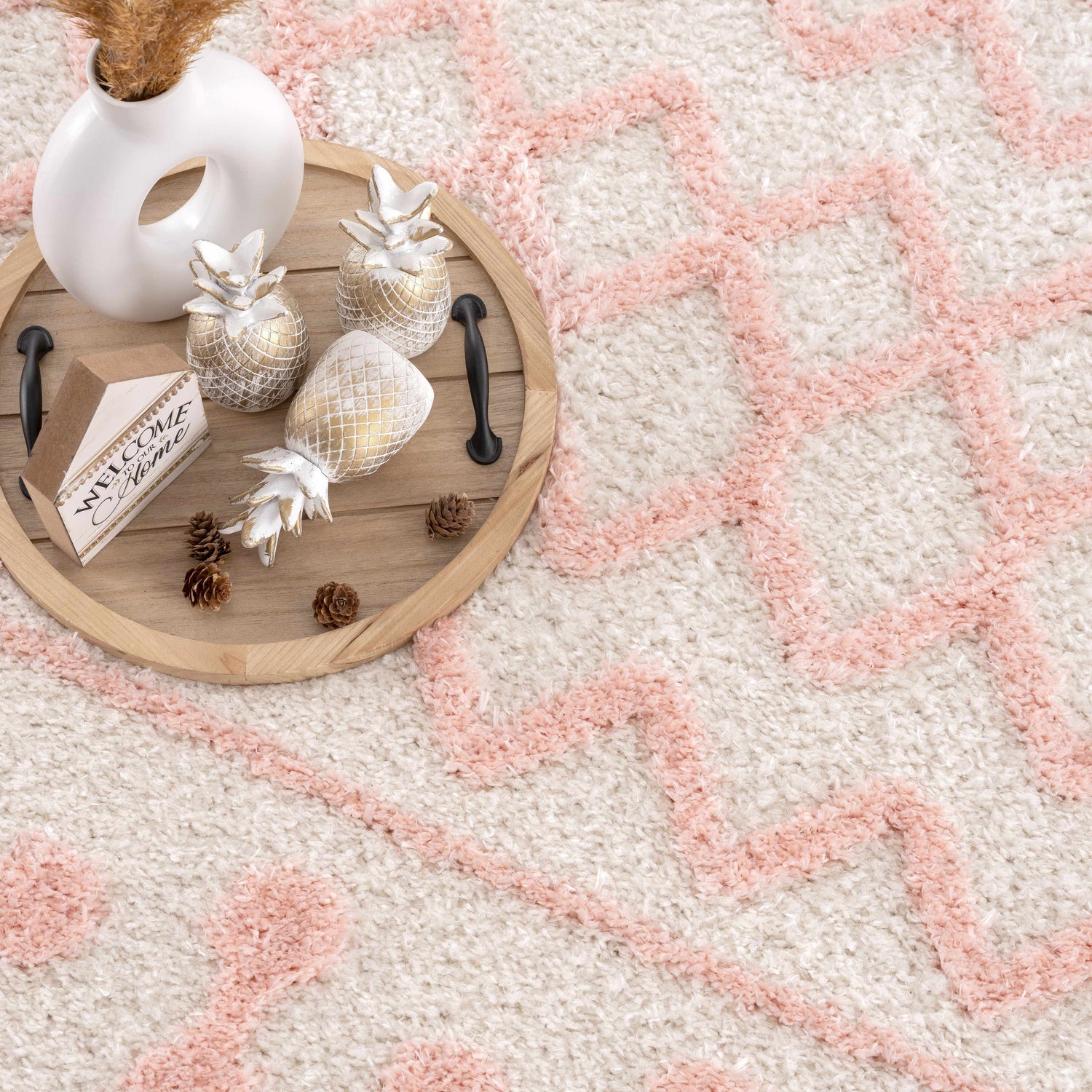 Close-up of the Darva Pink Plush Area Carpet, featuring a geometric design and soft, textured shag pile. Styleshot