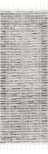 Close-up of the Nava Area Rug. Beige, bone, and black geometric pattern. Tassels on the ends. Design-Runner