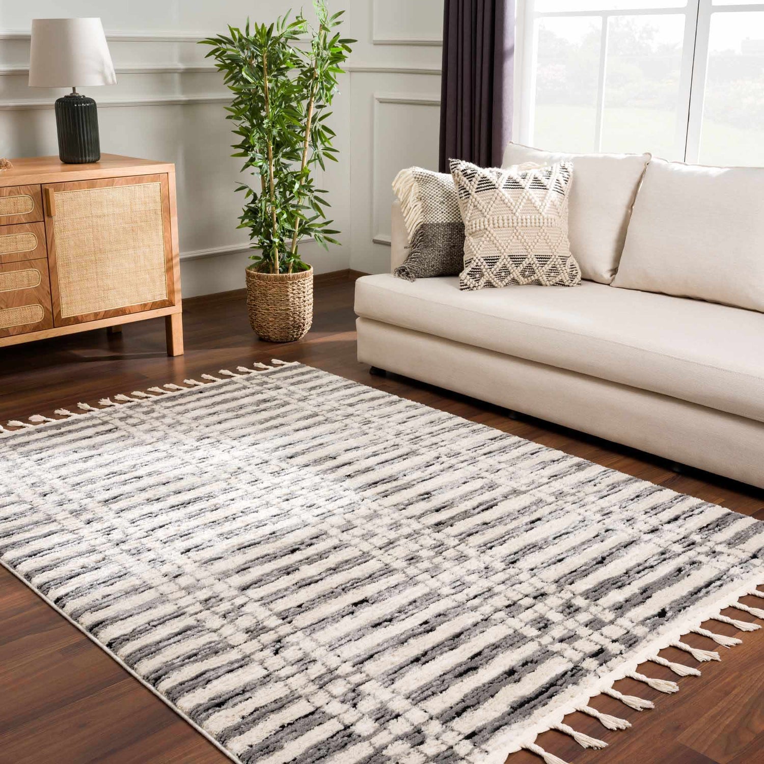 Living room scene with beige sofa and Nava Area Rug, a geometric design in beige, black, and bone. Roomscene-Rectangle