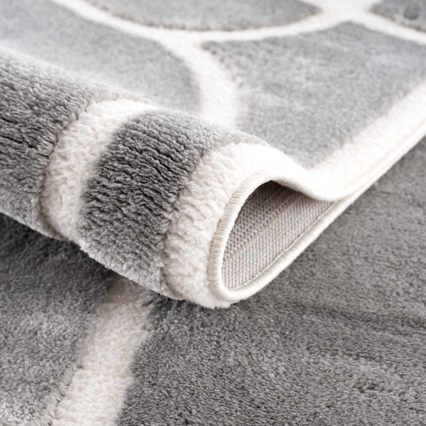 Close-up of the Azana Modern Gray Area Rug showing its geometric pattern, soft texture, and durable machine-woven construction. Fold