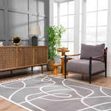 Living room scene with gray walls, wood furniture, and the Azana Modern Gray Area Rug. Roomscene-Rectangle