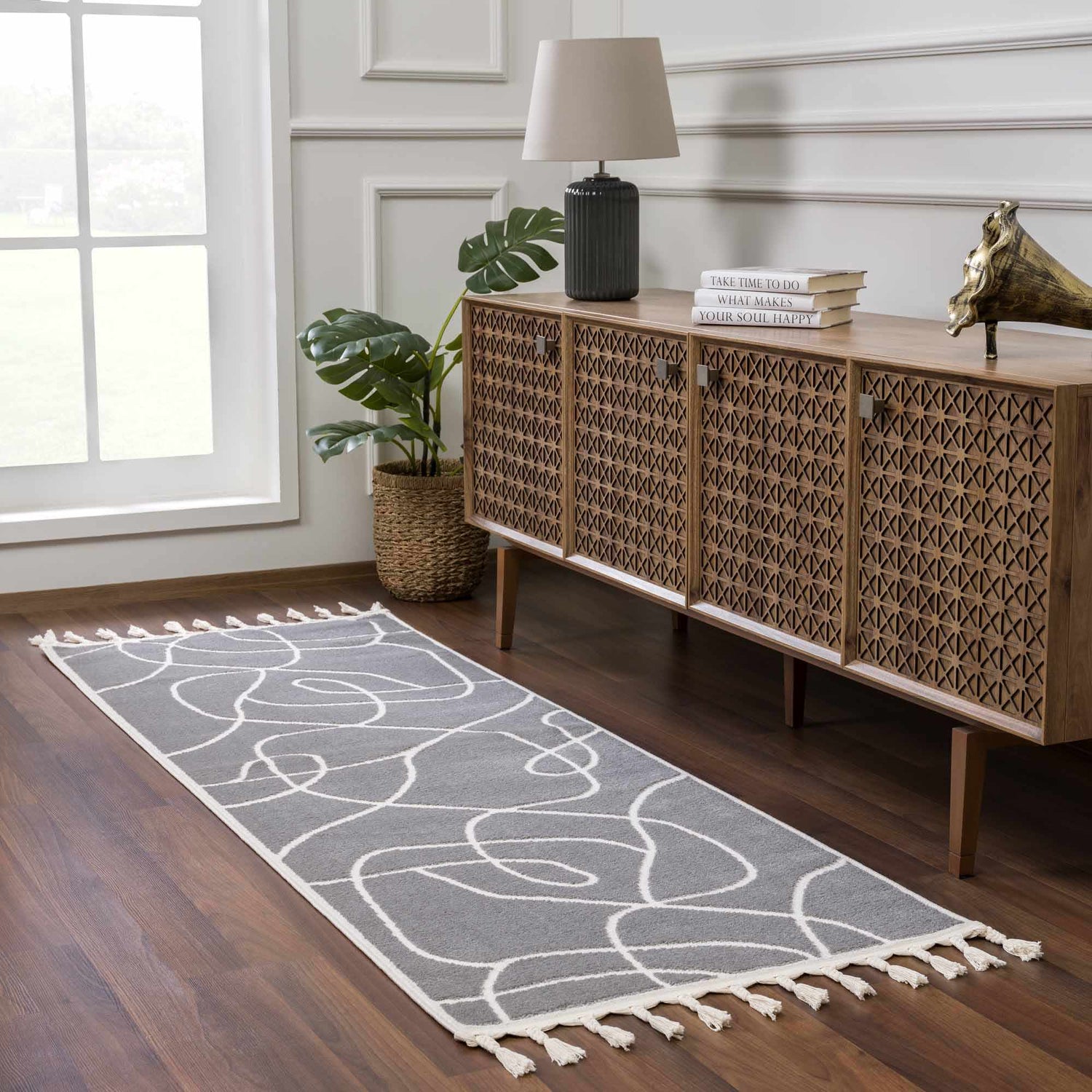 Hallway scene with Azana Modern Gray Area Rug runner, wood console table, lamp, and monstera plant. Roomscene-Runner