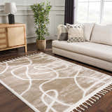 Living room scene with a cream sofa and the Azana Cream Area Rug with an abstract design and tassels. Roomscene-Rectangle