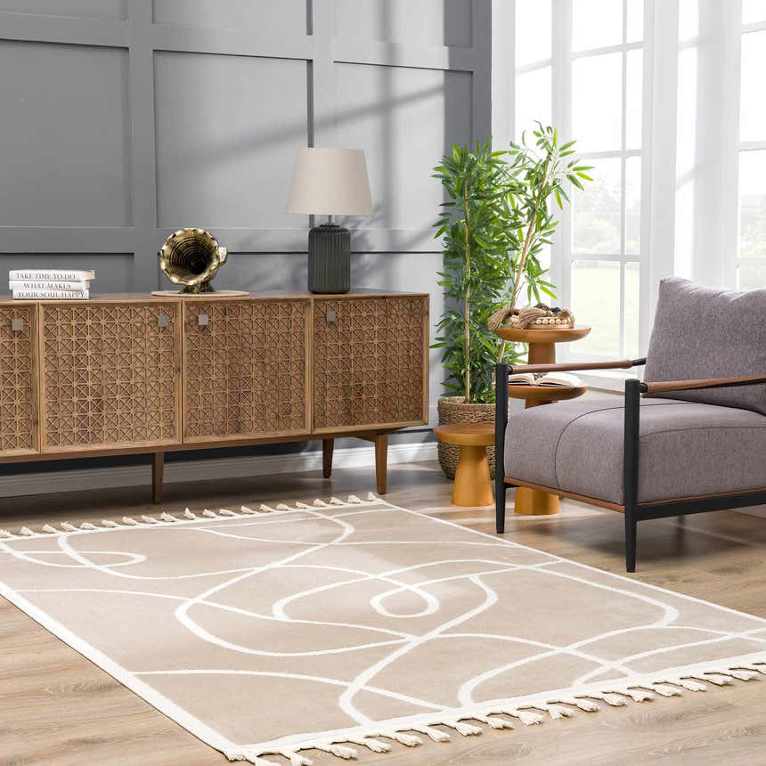 Living room scene with the cream Azana Area Rug featuring an abstract design and tassel fringe. Roomscene-Rectangle