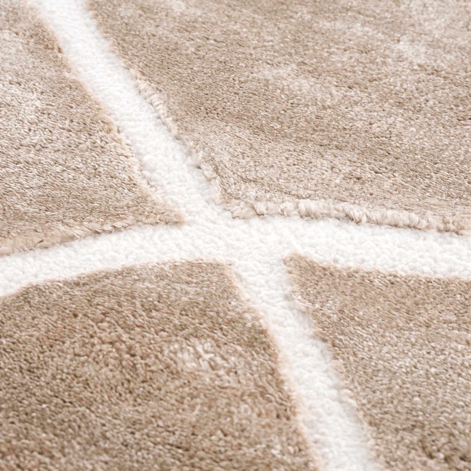 Close-up of the Azana Cream Area Rug showing the geometric pattern and soft, textured polypropylene material. Texture