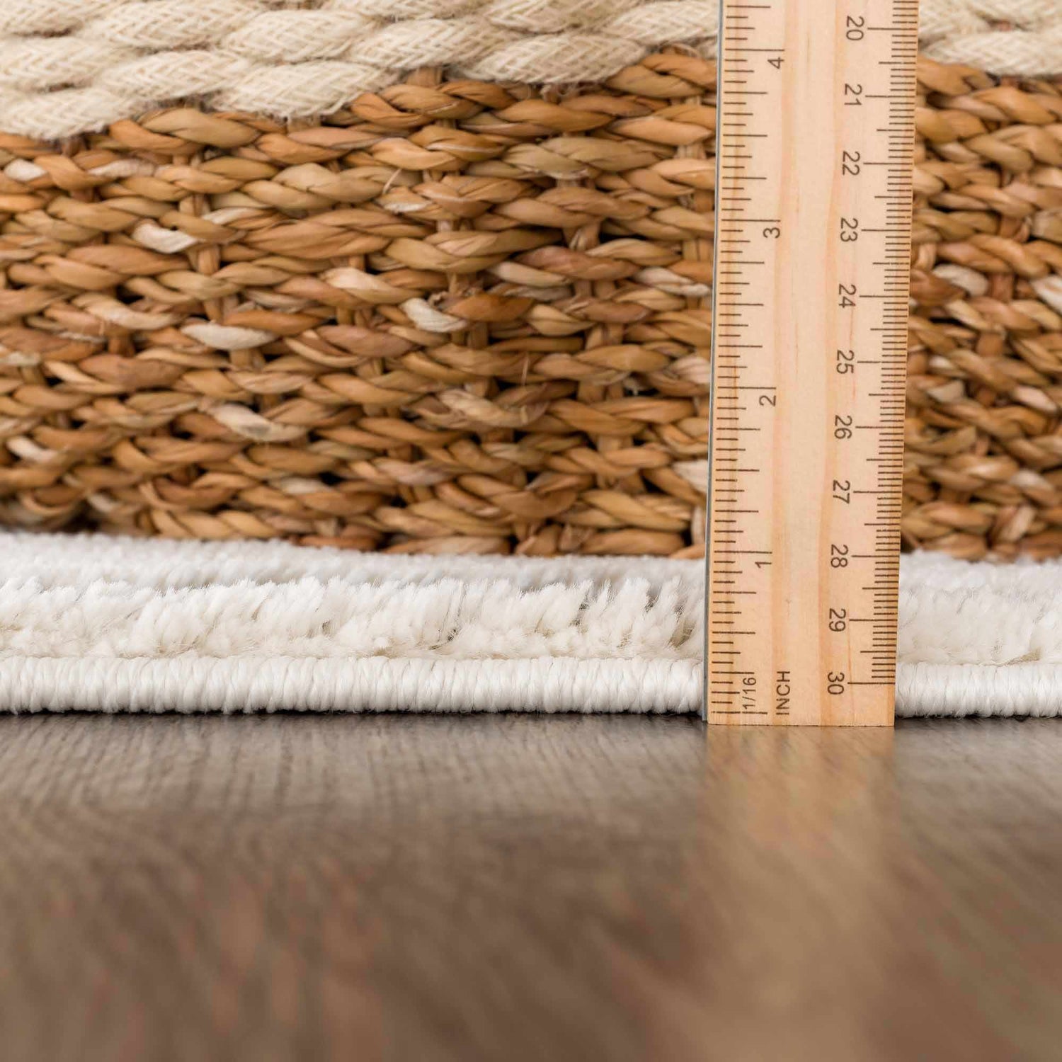 Close-up of the Bansi Area Rug showing the pile height and woven texture in beige and bone. Pile