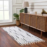 Entryway with Bansi Area Rug in beige and black, wooden console table, lamp, and dark wood floors. Roomscene-Runner