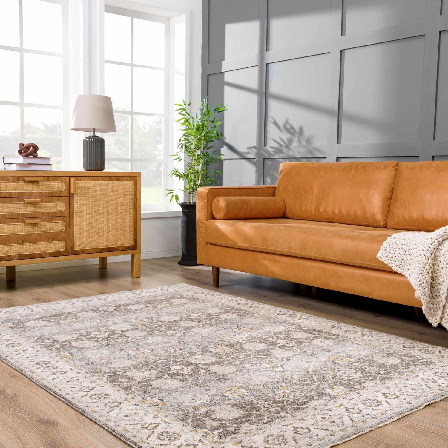Living room with a tan leather sofa and Amaru Green Textured Rug with Fringes. Roomscene-Rectangle