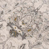 Close-up of the Gauge Cream & Gray Blue Rug. Features a traditional floral pattern in cream, gray, and blue hues. Soft, textured surface. Texture
