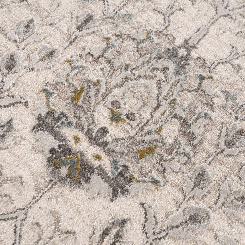 Close-up of the Gauge Cream & Gray Blue Rug. Features a traditional floral pattern in cream, gray, and blue hues. Soft, textured surface. Texture