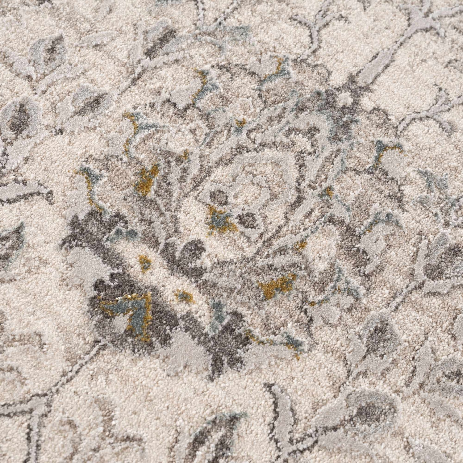 Close-up of the Gauge Cream & Gray Blue Rug. Features a traditional floral pattern in cream, gray, and blue hues. Soft, textured surface. Texture
