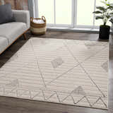 Living room scene with a beige Lexi Area Rug featuring a geometric design. Gray sofa and wood floors. Roomscene-Rectangle