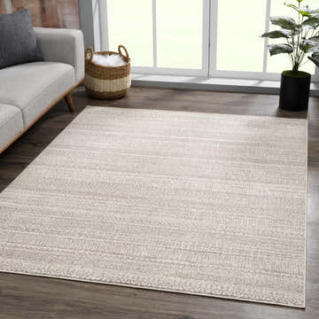 Living room scene with a Nate Beige Tribal high pile carpet, gray sofa, and natural light. Roomscene-Rectangle