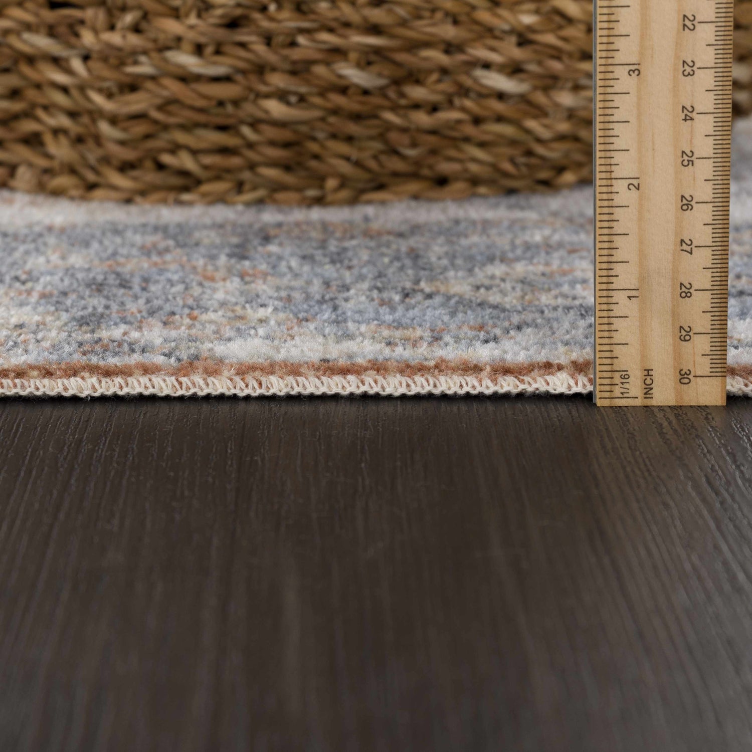 Close-up of Blue Orange Hera Washable rug pile height, showing texture and colors with ruler for scale. Pile