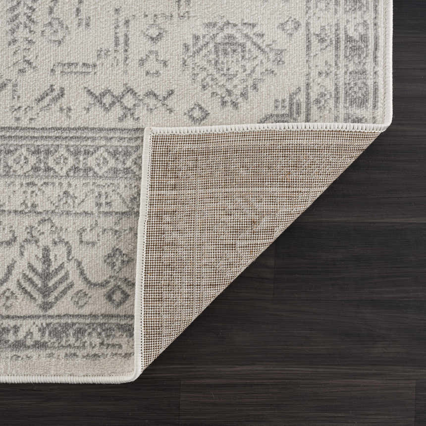 Close-up of Tigried Ivory & Gray 2323 Area Rug showing its traditional gray pattern, ivory color, and rug backing. Fold
