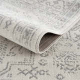 Close-up of the Tigried Ivory & Gray 2323 Area Rug showing its soft texture and bohemian-inspired gray pattern on an ivory base. Fold