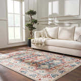 Living room scene with Bindi Blue & Rose Area Rug, beige sofa, wood floors, and bright natural light. Southwestern style. Roomscene-Rectangle