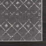 Close-up of the Tigrican Charcoal 2329 rug. Features a black and ivory Moroccan-inspired diamond pattern. Swatch