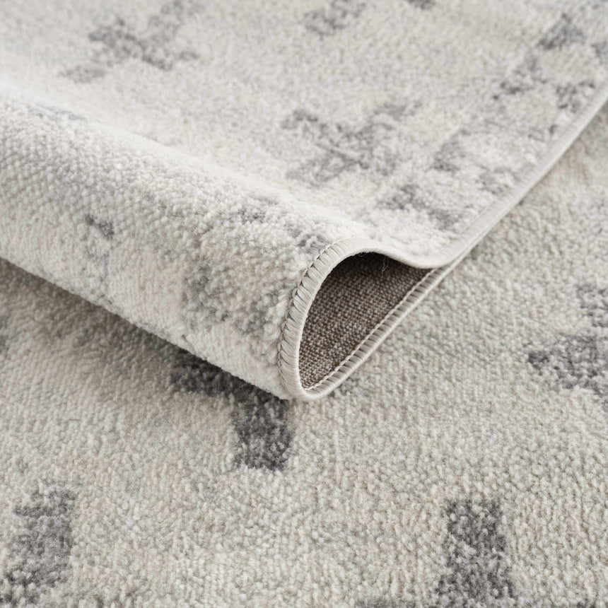 Close-up of the Tigris Swiss Cross Ivory&Gray Area Rug showing its geometric pattern and soft, textured polypropylene material. Fold