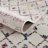 Close-up of the Tigrican Colorful 2333 area rug showing the ivory base and colorful geometric Moroccan-inspired pattern. Fold