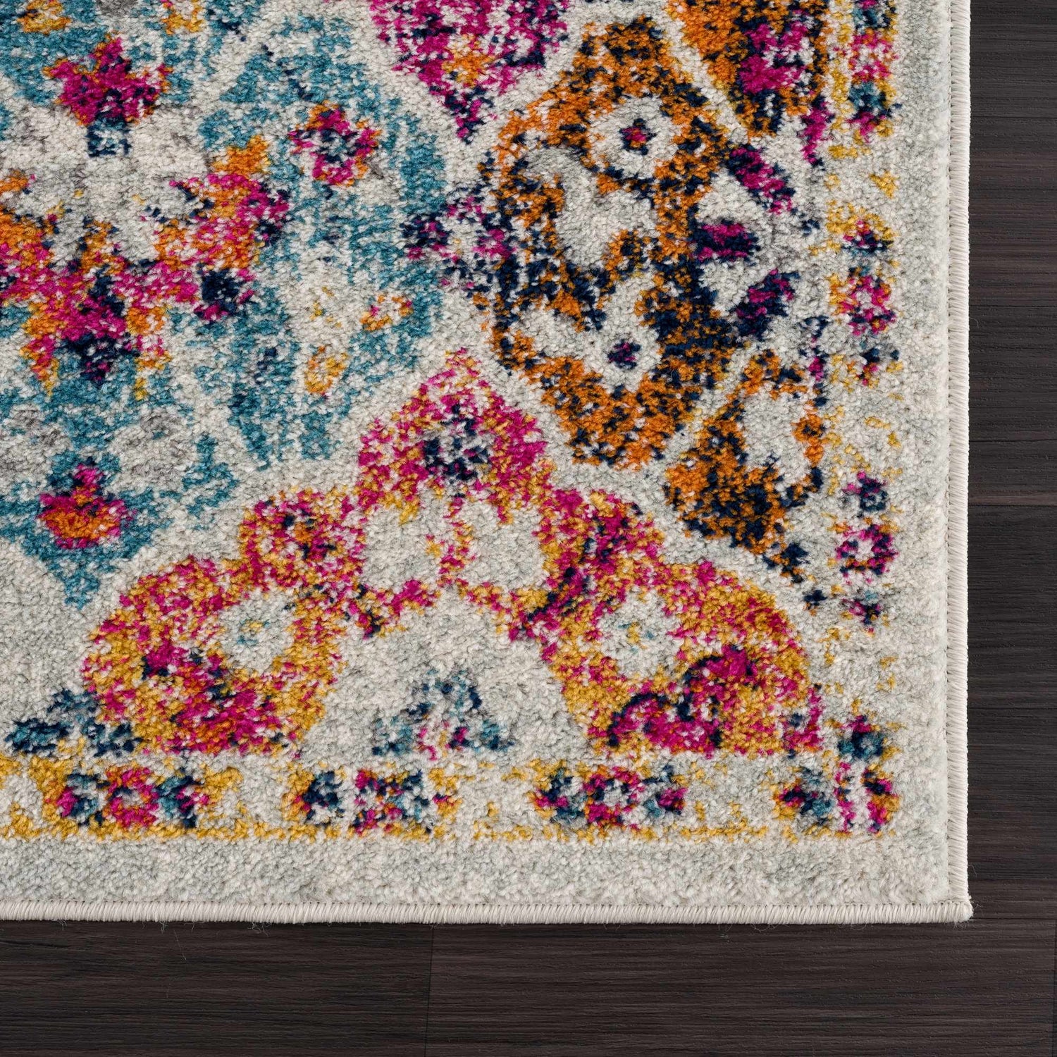 Close-up of the New Custar Area Rug: a traditional, machine-woven rug with burgundy, orange, teal, and pink floral patterns. Corner