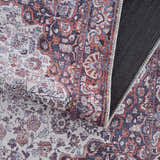 Close-up of the Red Cael Tumble Dry Washable Rug showing the traditional Persian-style pattern and colors. Fold