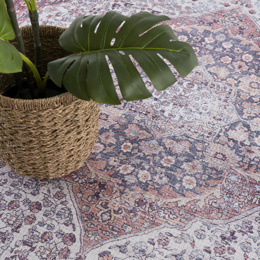 Close-up of the Red Cael Tumble Dry Washable Rug featuring a vintage Persian pattern in red, navy, and off-white colors. Styleshot
