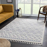 Living room scene featuring a Magnolia Blue 2302 Area Rug with geometric design, mustard sofa, and modern chair. Roomscene-Rectangle