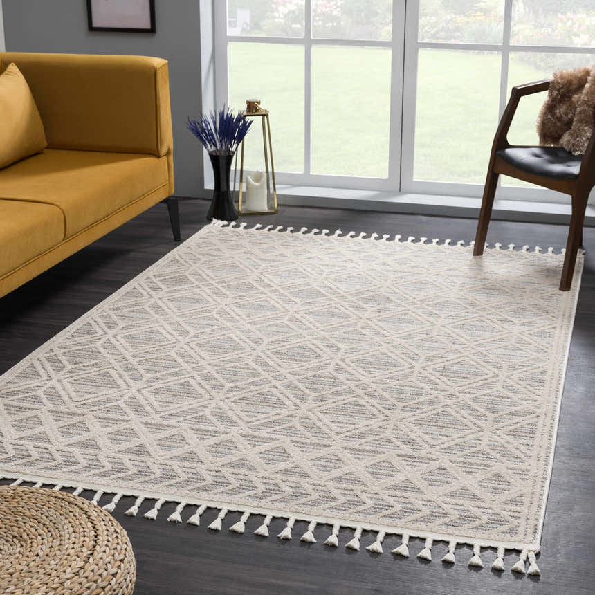 Living room scene with a Magnolia Beige 2301 Area Rug, yellow sofa, and geometric pattern. Tassels accent the rug's edge. Roomscene-Rectangle