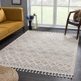 Living room scene with a Magnolia Cream 2300 Area Rug, mustard sofa, wood chair, and natural light. Geometric, farmhouse style. Roomscene-Rectangle