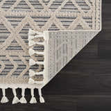 Close-up of Magnolia Cream 2300 Area Rug showing geometric design, tassels, and durable machine-woven construction. Fold