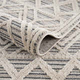 Close up of geometric Magnolia Cream 2300 Area Rug showing beige, cream, and gray tones and textured, machine-woven construction. Fold