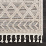Close-up of Magnolia Beige 2301 Area Rug showing geometric pattern, beige and brown tones, and braided fringe detail. Corner