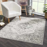 Living room scene with a white chair on a Marash KMRSH-4615 area rug in black, gray, and ivory. Roomscene-Rectangle