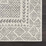 Close-up of Marash KMRSH-4611 area rug with gray geometric patterns on ivory. Contemporary farmhouse style. Corner